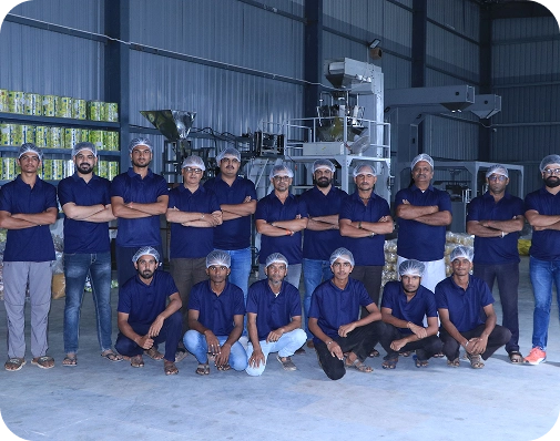 Group of Launch My Brand factory team standing production facility.
